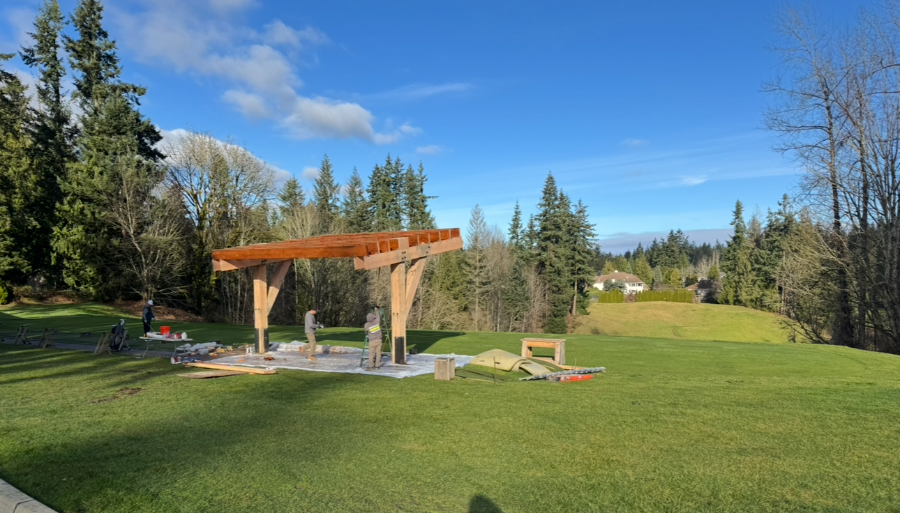 TimberShield structure under construction — V-leg steel base plates being set